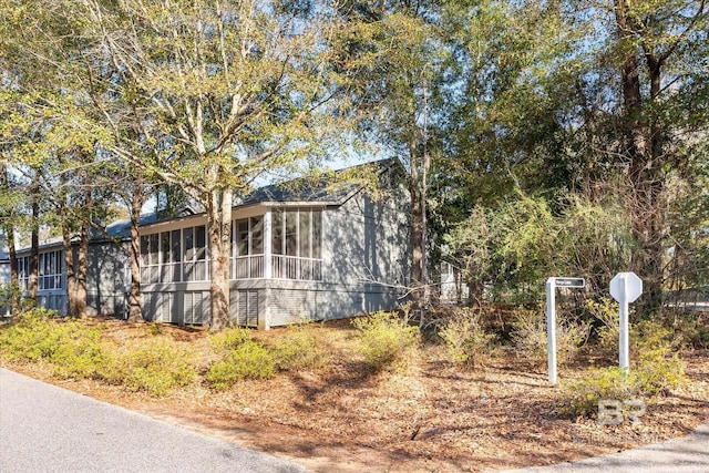 view of side of property with a sunroom