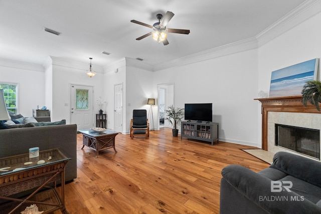 22091 Pecan Loop, Silverhill, AL 36576 - living area with ornamental molding, ceiling fan, wood finished floors, and a tiled fireplace