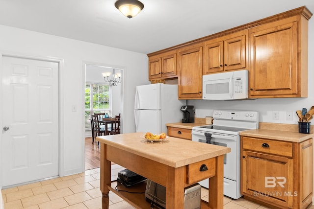 22091 Pecan Loop, Silverhill, AL 36576 - kitchen featuring white appliances, light countertops, brown cabinetry, and a chandelier