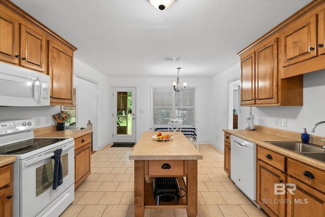 22091 Pecan Loop, Silverhill, AL 36576 - kitchen featuring white appliances, brown cabinets, and light countertops