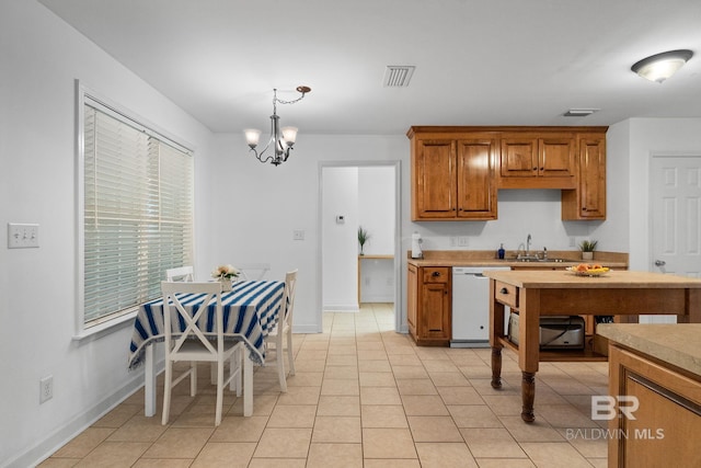 22091 Pecan Loop, Silverhill, AL 36576 - kitchen featuring white dishwasher, a chandelier, brown cabinetry, decorative light fixtures, and light countertops