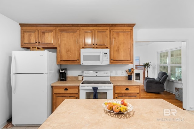 22091 Pecan Loop, Silverhill, AL 36576 - kitchen with white appliances, light countertops, brown cabinets, and light wood-type flooring
