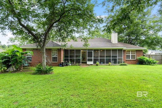 22091 Pecan Loop, Silverhill, AL 36576 - back of property featuring a chimney, a sunroom, and brick siding