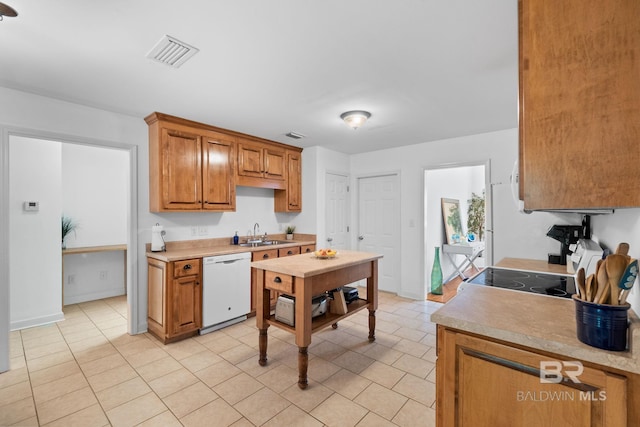 22091 Pecan Loop, Silverhill, AL 36576 - kitchen with dishwasher, light countertops, brown cabinets, and light tile patterned flooring