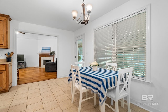 22091 Pecan Loop, Silverhill, AL 36576 - dining room with a chandelier, light tile patterned floors, and a fireplace