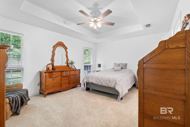 22091 Pecan Loop, Silverhill, AL 36576 - bedroom with a raised ceiling, light colored carpet, and a ceiling fan