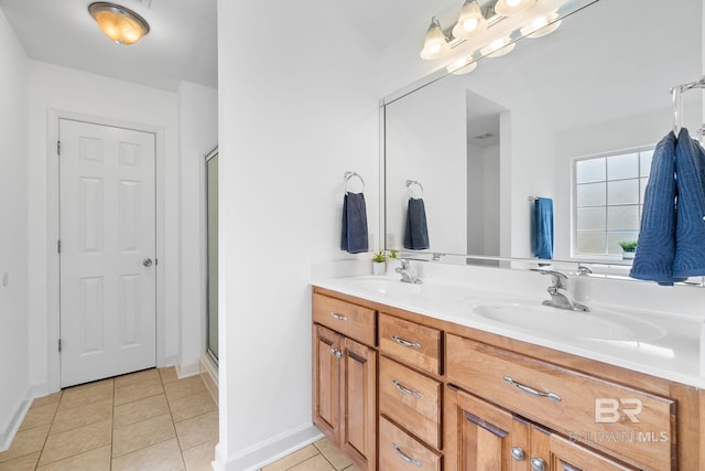 22091 Pecan Loop, Silverhill, AL 36576 - bathroom featuring tile patterned flooring, double vanity, and a shower with shower door
