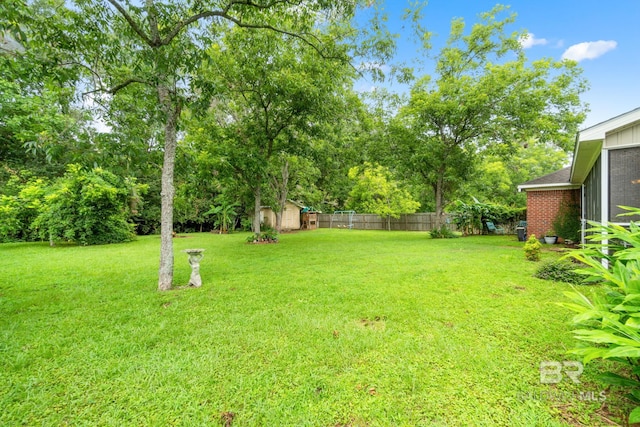 22091 Pecan Loop, Silverhill, AL 36576 - view of yard with a storage unit and view of wooded area
