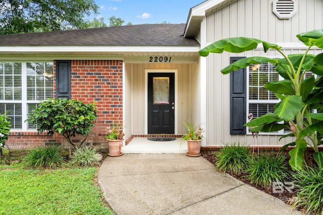 22091 Pecan Loop, Silverhill, AL 36576 - doorway to property with roof with shingles and brick siding