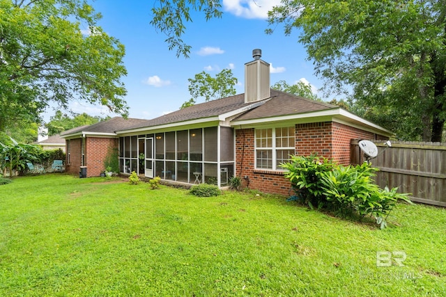22091 Pecan Loop, Silverhill, AL 36576 - rear view of house featuring brick siding, a sunroom, and a chimney