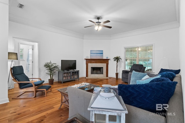 22091 Pecan Loop, Silverhill, AL 36576 - living area with ornamental molding, ceiling fan, wood finished floors, and a fireplace with flush hearth