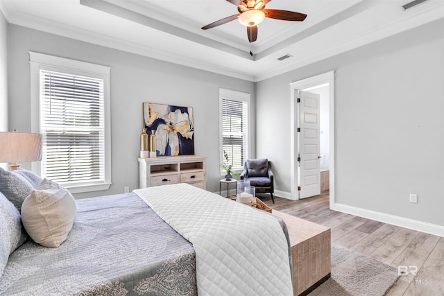 23901 Cypress Xing, Orange Beach, AL 36561 - bedroom with a raised ceiling, wood finished floors, multiple windows, and visible vents