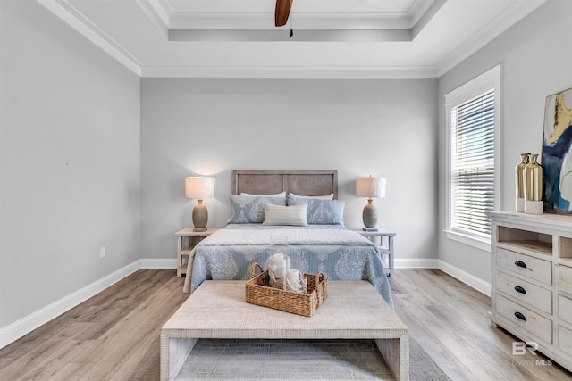 23901 Cypress Xing, Orange Beach, AL 36561 - bedroom featuring baseboards, ornamental molding, light wood-type flooring, and a raised ceiling