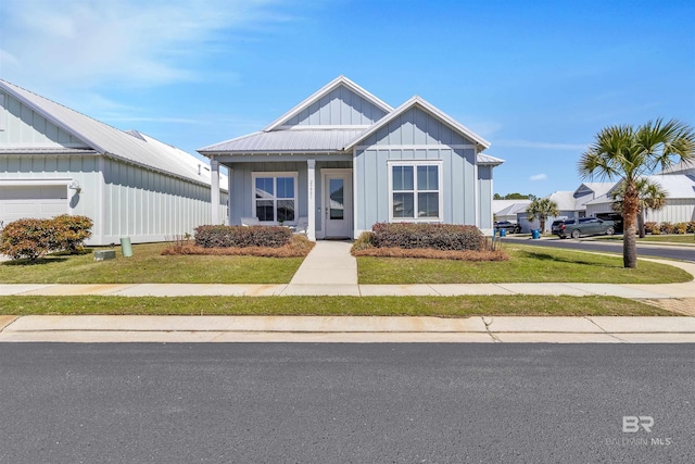 23901 Cypress Xing, Orange Beach, AL 36561 - view of front of house featuring board and batten siding and a front yard