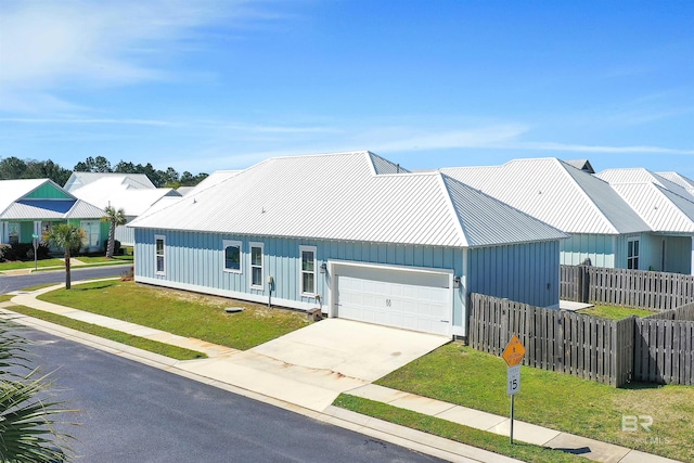 23901 Cypress Xing, Orange Beach, AL 36561 - view of front of home with fence, a garage, a front lawn, board and batten siding, and driveway