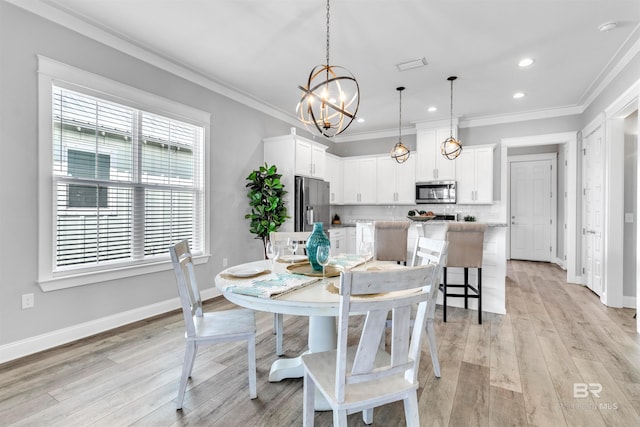 23901 Cypress Xing, Orange Beach, AL 36561 - dining space with light wood finished floors, ornamental molding, baseboards, and a chandelier
