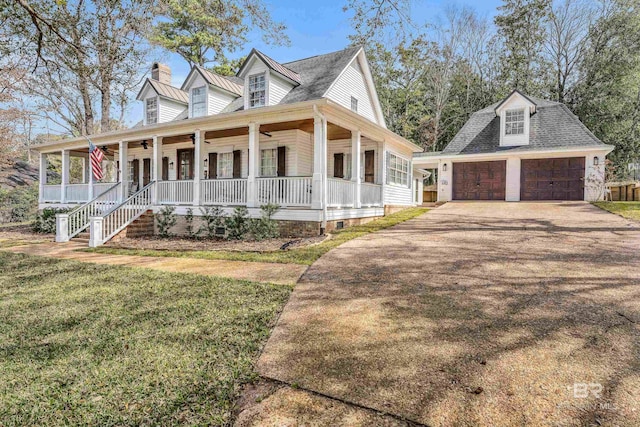 view of front of home with covered porch, a ceiling fan, driveway, a front lawn, and a chimney