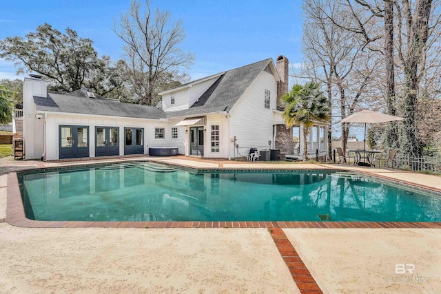 outdoor pool featuring french doors, central AC, and a patio