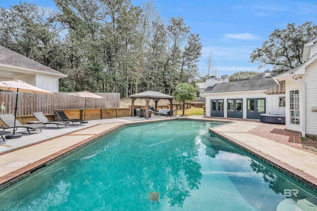 view of pool with a gazebo, a patio area, a fenced backyard, and a fenced in pool