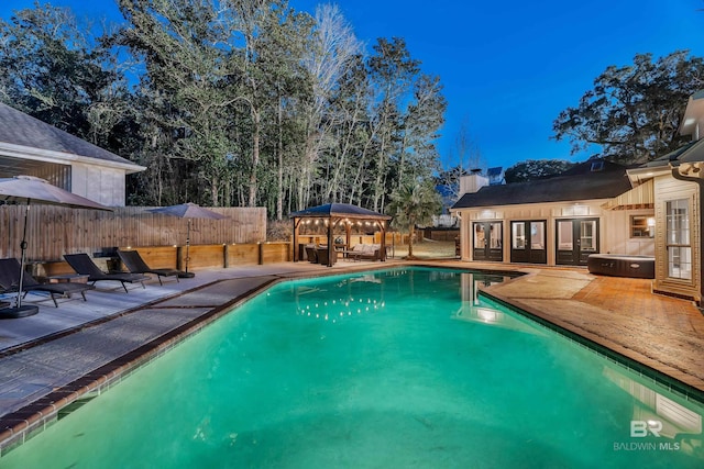 view of swimming pool with a gazebo, a patio, fence, and a fenced in pool