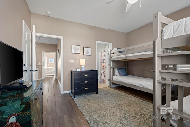 bedroom featuring connected bathroom, hardwood / wood-style flooring, and ceiling fan