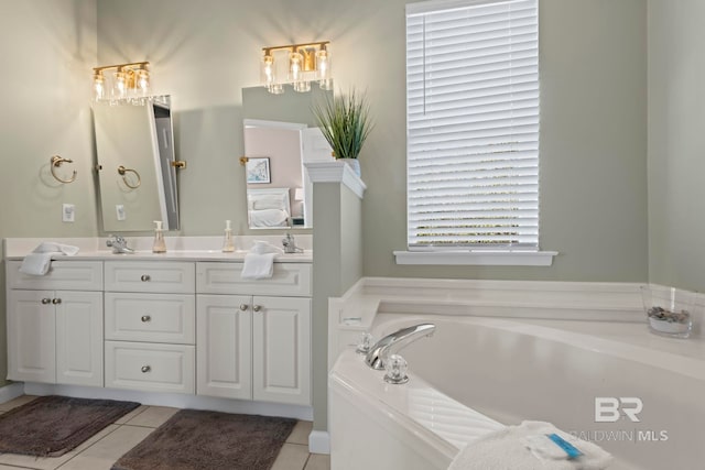 bathroom featuring tile patterned flooring, vanity, and a washtub