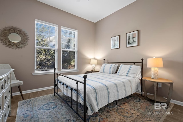 bedroom with dark hardwood / wood-style floors