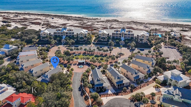 birds eye view of property featuring a beach view and a water view