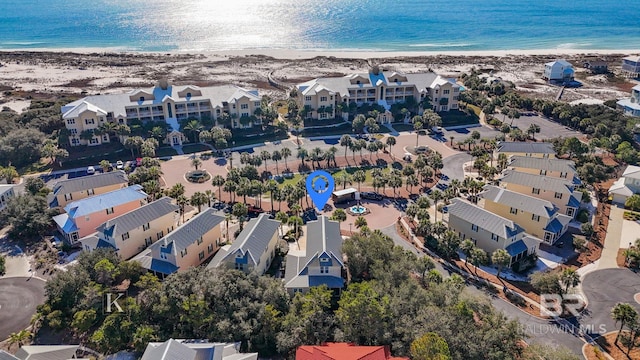 birds eye view of property featuring a beach view and a water view