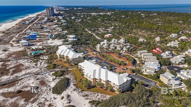 aerial view with a water view and a view of the beach