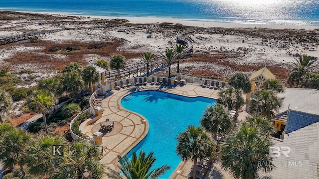 view of pool with a water view and a view of the beach