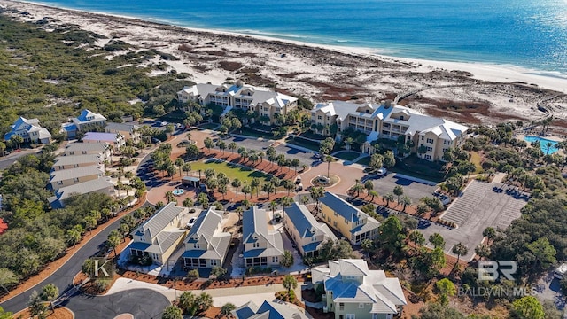 bird's eye view with a water view and a beach view