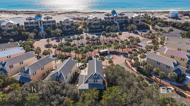 drone / aerial view with a beach view and a water view