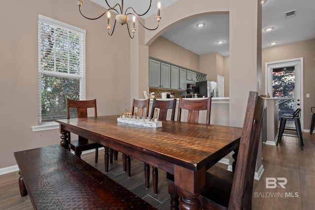 dining space featuring a chandelier and dark wood-type flooring