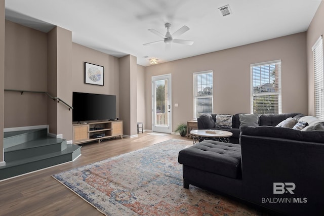 living room featuring ceiling fan and hardwood / wood-style floors