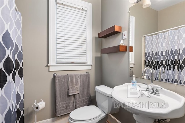 bathroom featuring toilet and sink