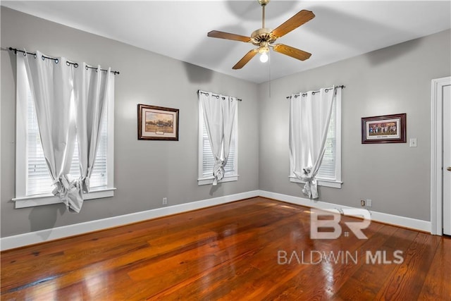 unfurnished room with ceiling fan, hardwood / wood-style flooring, and a wealth of natural light