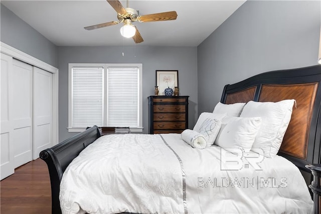 bedroom with a closet, ceiling fan, and dark hardwood / wood-style flooring