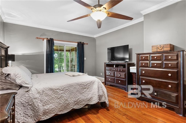 bedroom with hardwood / wood-style floors, ceiling fan, crown molding, and access to exterior