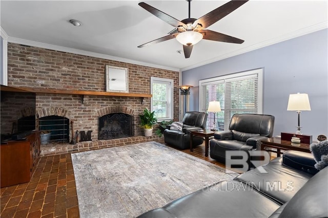 living room with a fireplace, ceiling fan, brick wall, and ornamental molding