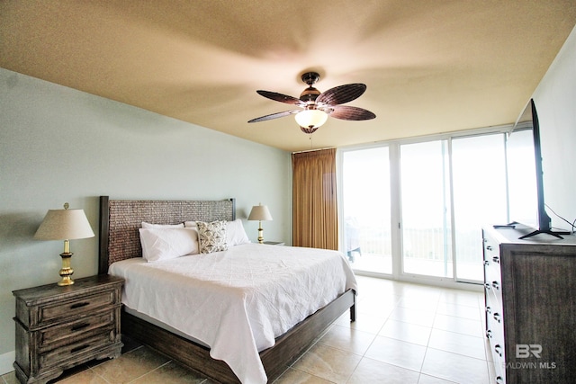 bedroom with access to outside, expansive windows, ceiling fan, a textured ceiling, and light tile patterned flooring