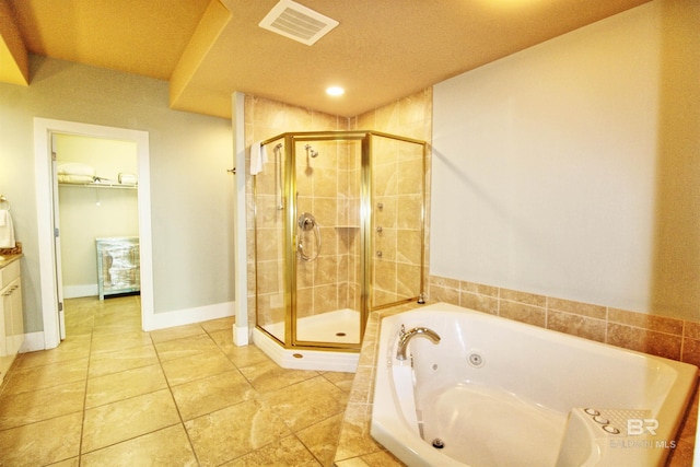 bathroom featuring vanity, tile patterned flooring, plus walk in shower, and a textured ceiling