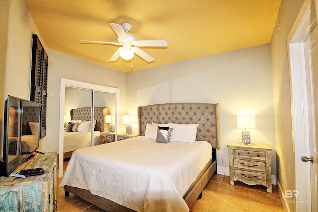 bedroom with tile patterned floors, ceiling fan, and a closet