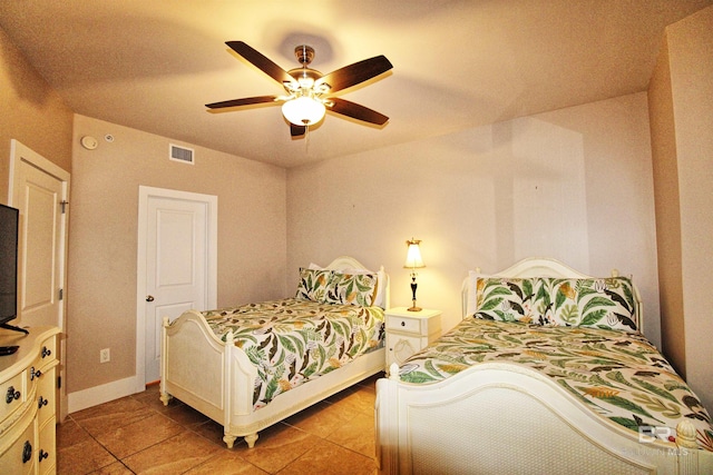 bedroom with tile patterned floors and ceiling fan