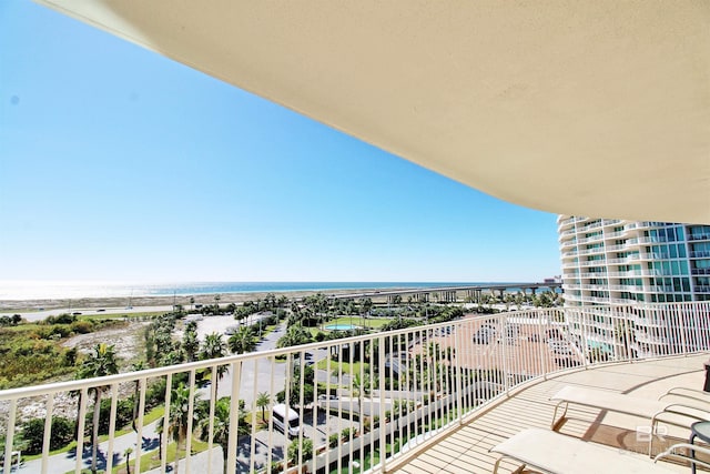 balcony with a water view and a beach view