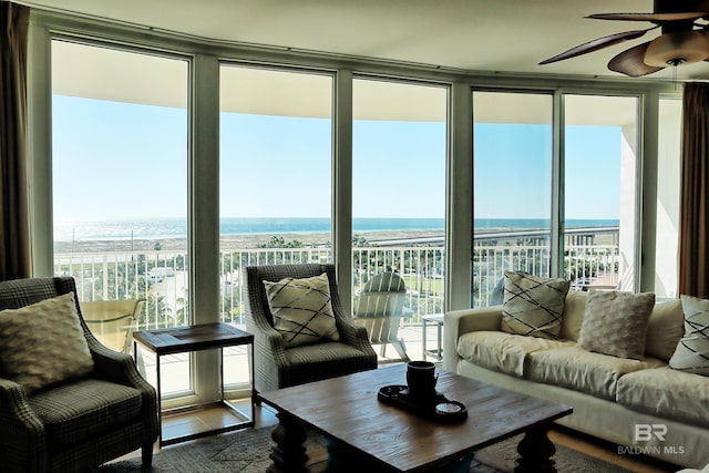 sunroom / solarium with plenty of natural light and a water view