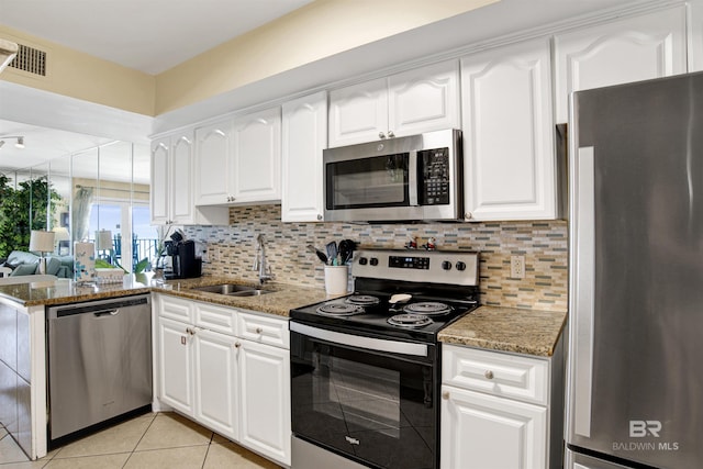 969 W Beach Blvd Unit 1503A, Gulf Shores, AL 36542 - kitchen with stainless steel appliances, light tile patterned flooring, and light stone counters