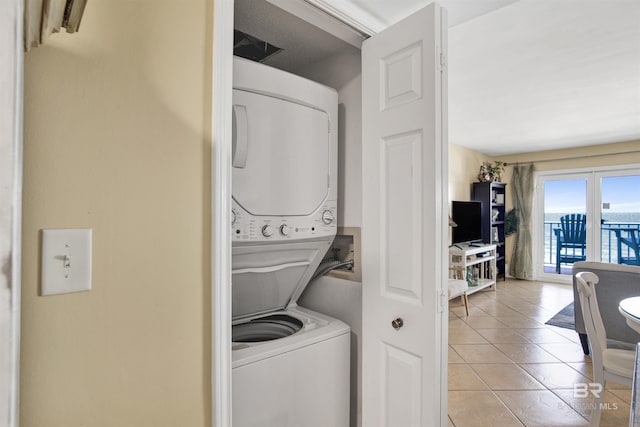 969 W Beach Blvd Unit 1503A, Gulf Shores, AL 36542 - laundry area featuring estacked washer and dryer and light tile patterned floors