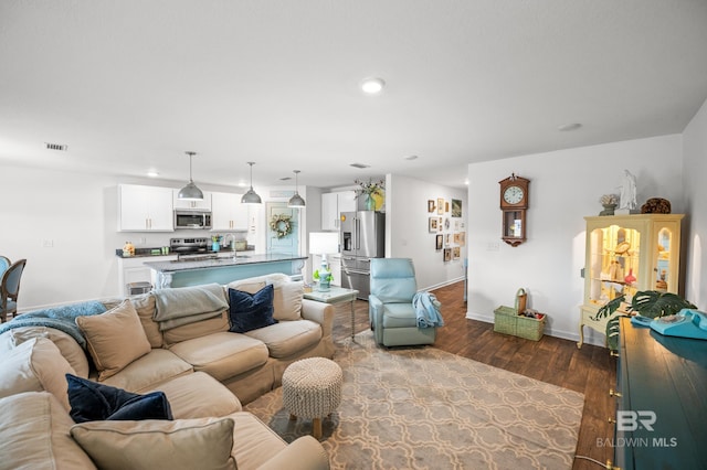 living room with sink and hardwood / wood-style floors