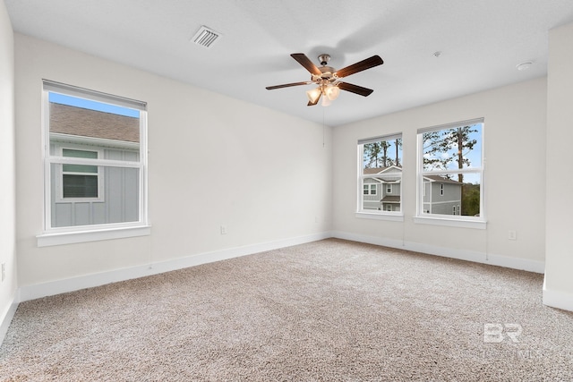 carpeted empty room featuring ceiling fan